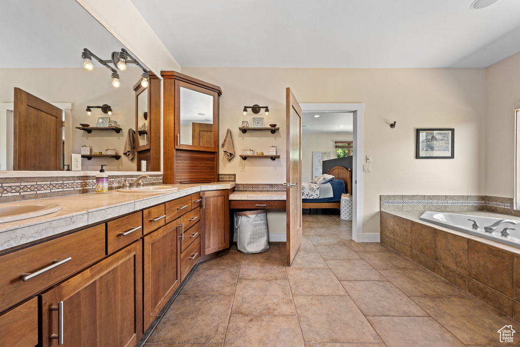 Full bath with double vanity, a bath, ensuite bathroom, and tile patterned flooring