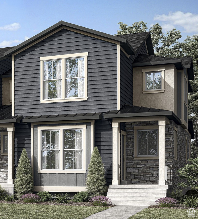 View of front of property with stone siding and stucco siding