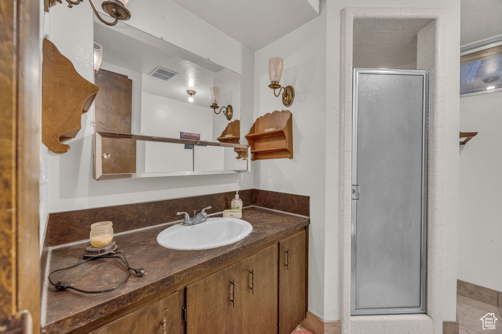 Bathroom with vanity and a stall shower