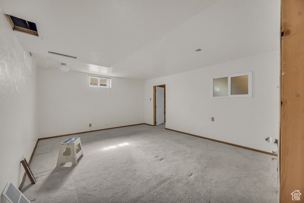 Spare room with carpet and baseboards
