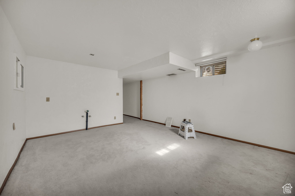 Below grade area featuring carpet and baseboards