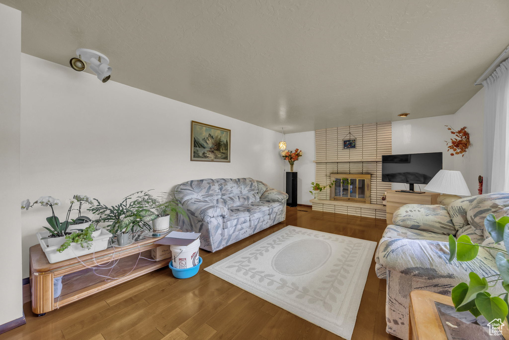 Living room with wood finished floors and a brick fireplace