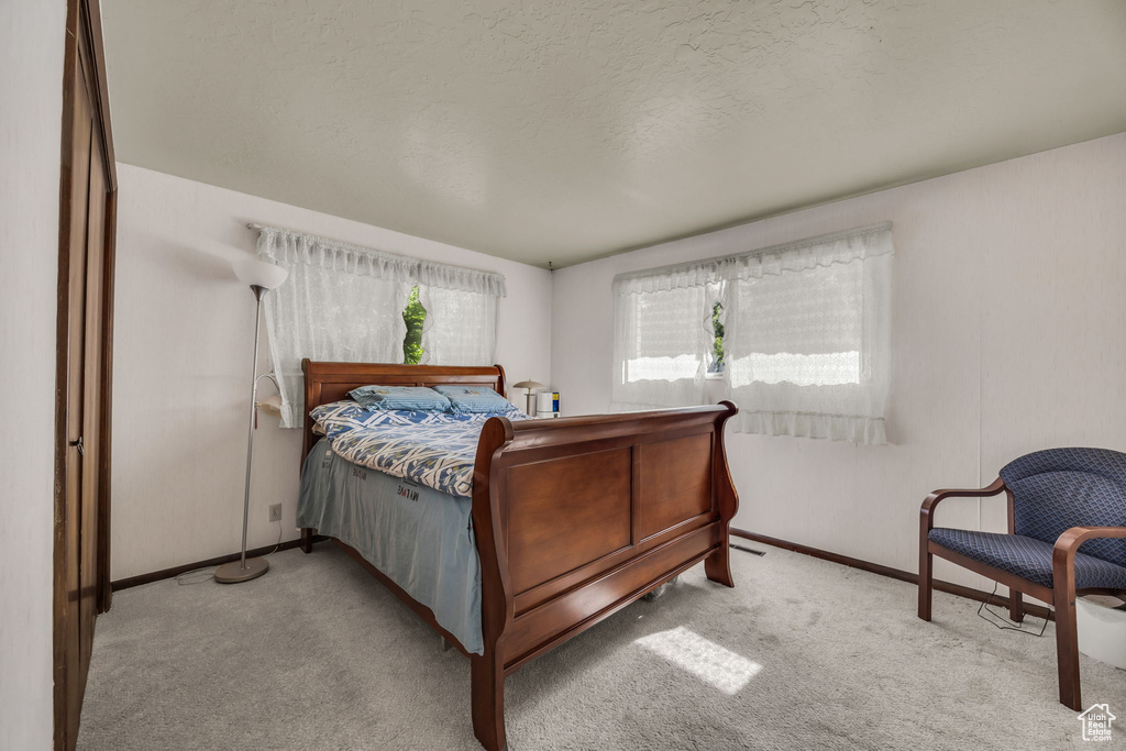 Carpeted bedroom featuring baseboards