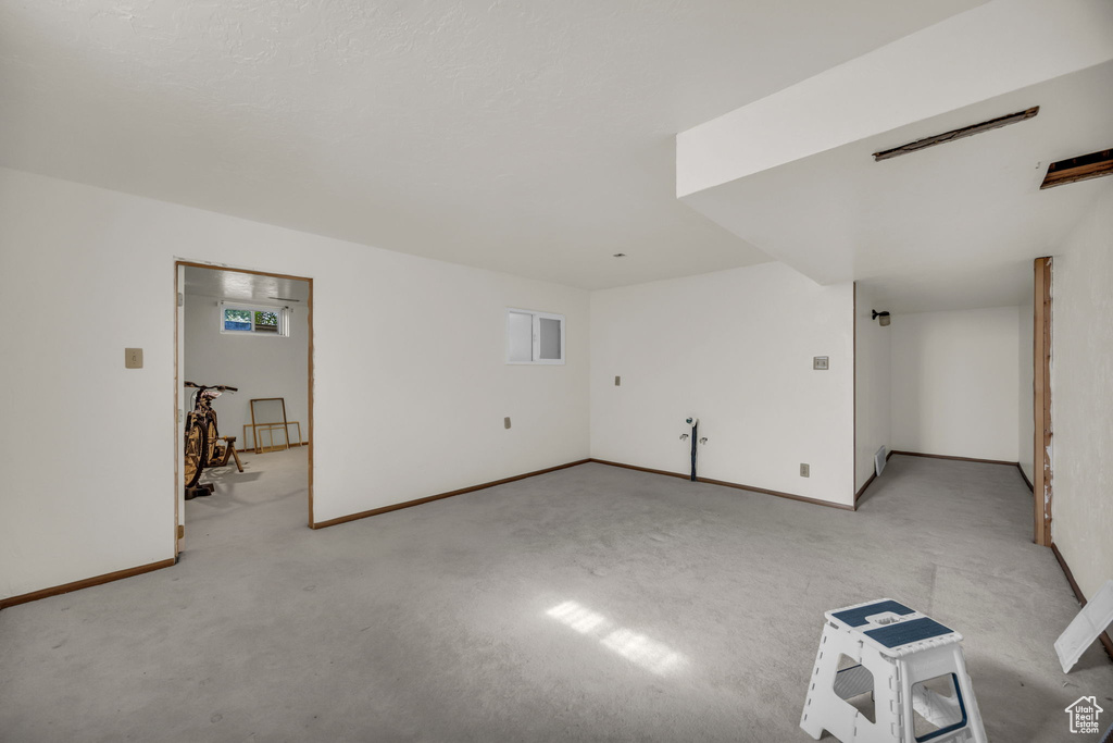 Unfurnished living room with light colored carpet