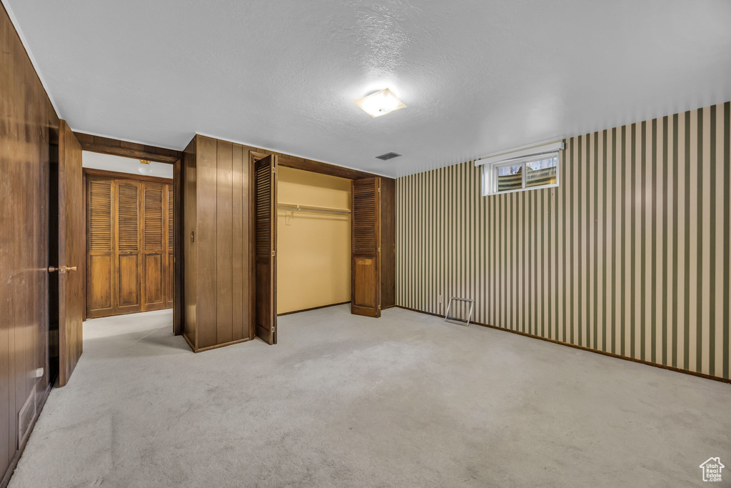 Unfurnished bedroom featuring a closet, carpet, and a textured ceiling