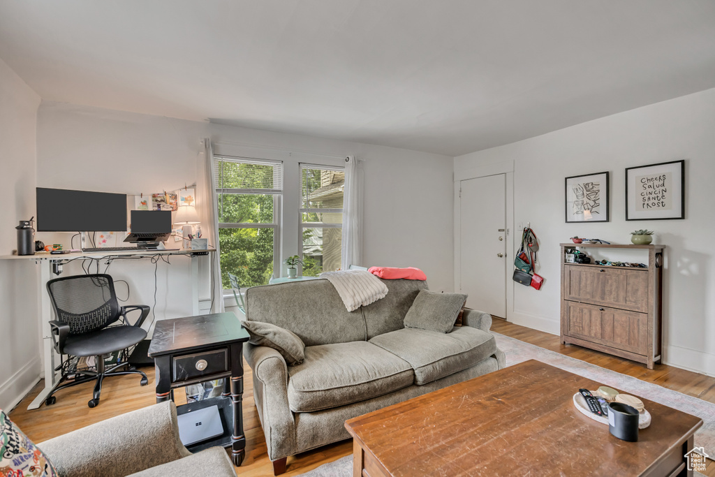 Living area featuring a desk and light wood-style floors