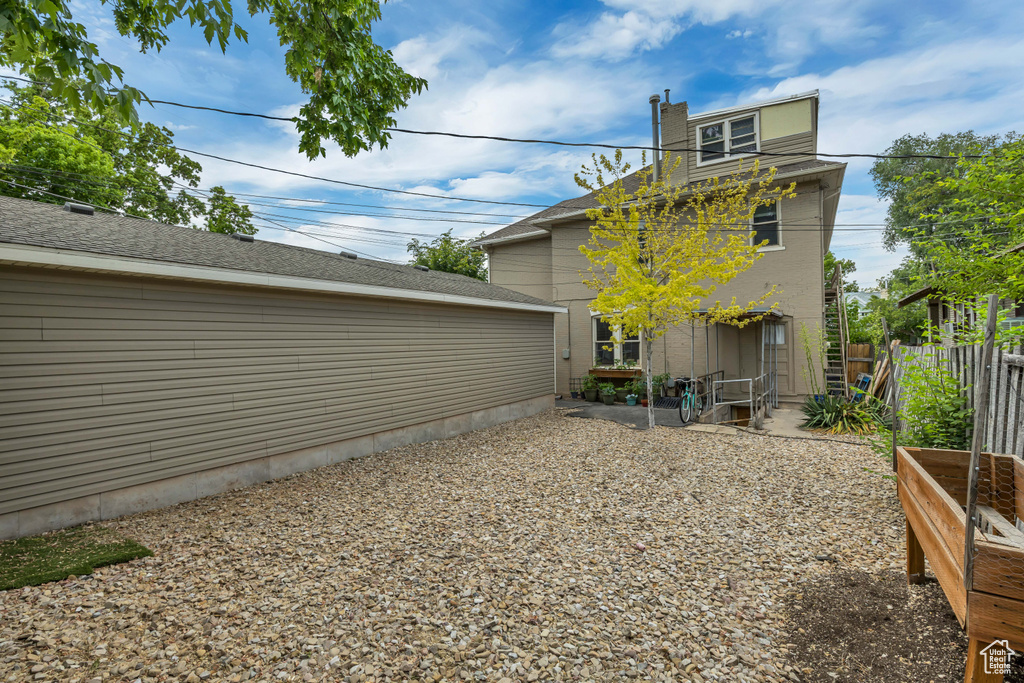 Back of house with a vegetable garden