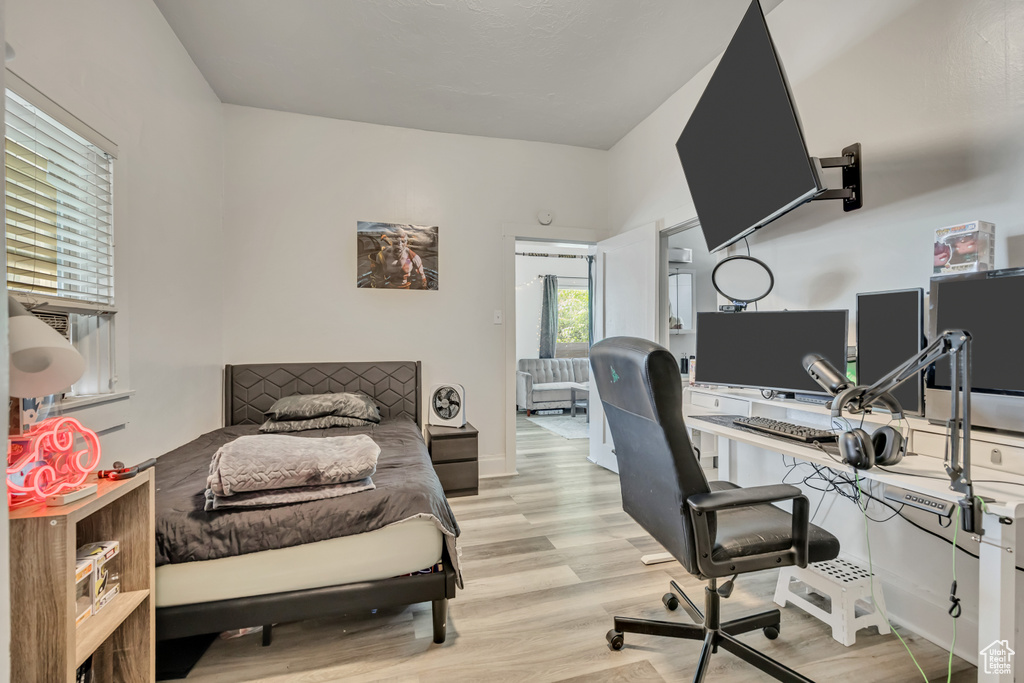 Bedroom featuring light wood-style flooring and a desk