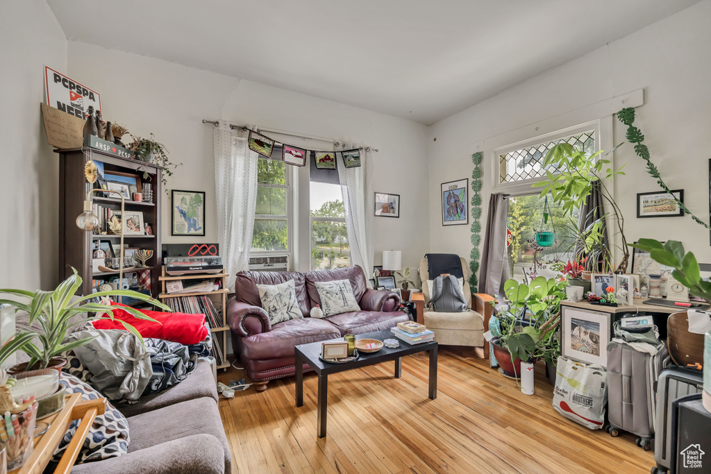 Living area with healthy amount of natural light and wood-type flooring