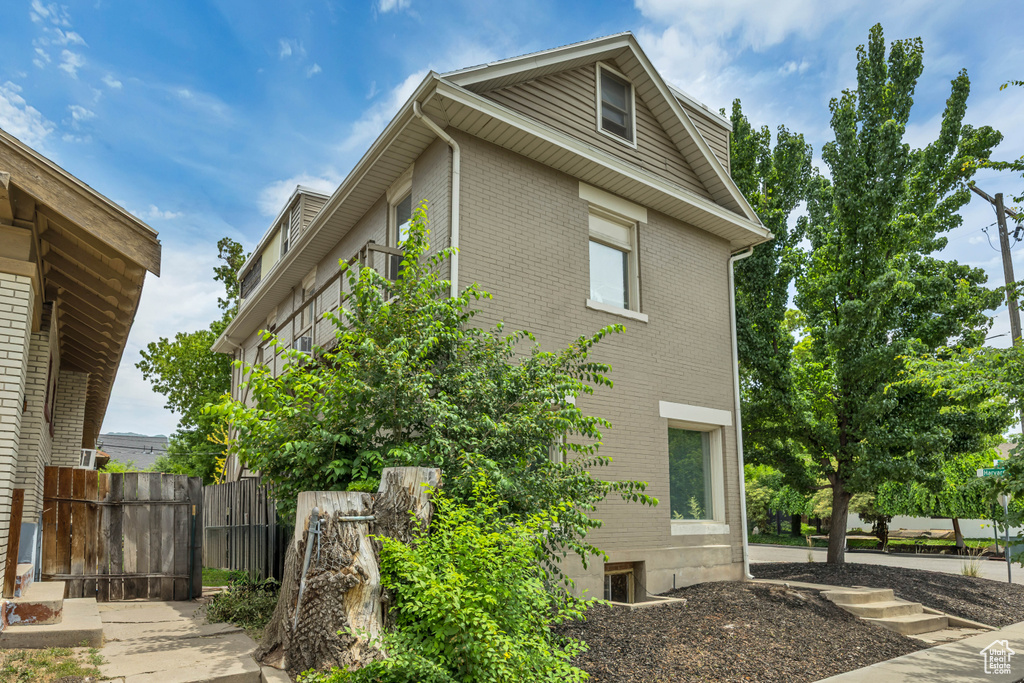 View of side of home with brick siding