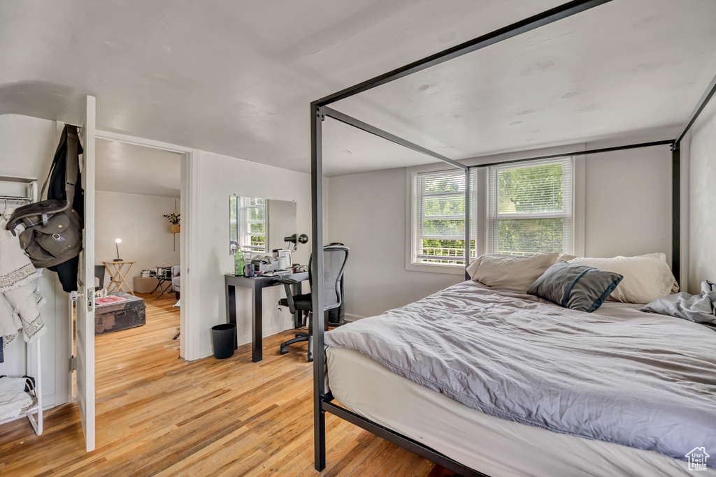 Bedroom featuring light wood finished floors and a desk