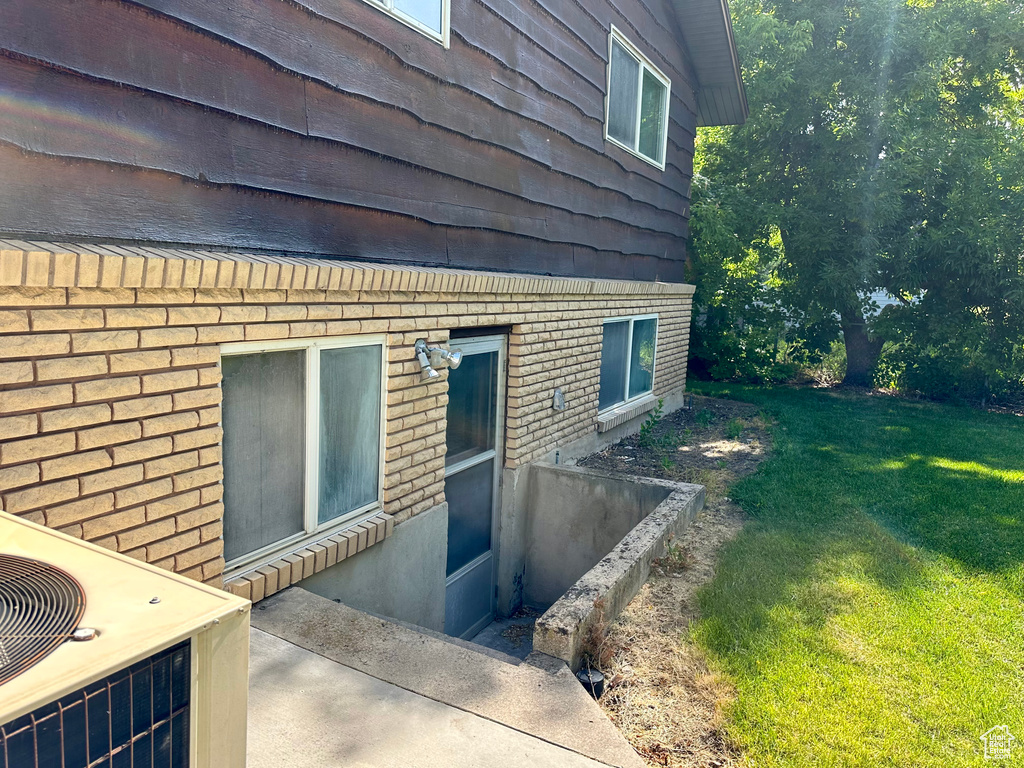 View of home\\\'s exterior with a yard and brick siding