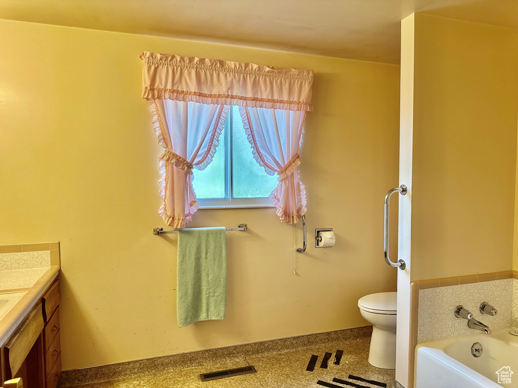 Bathroom featuring vanity and a garden tub