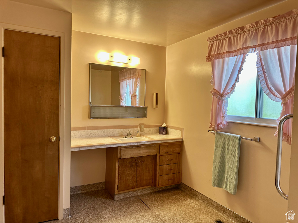 Bathroom with vanity and baseboards