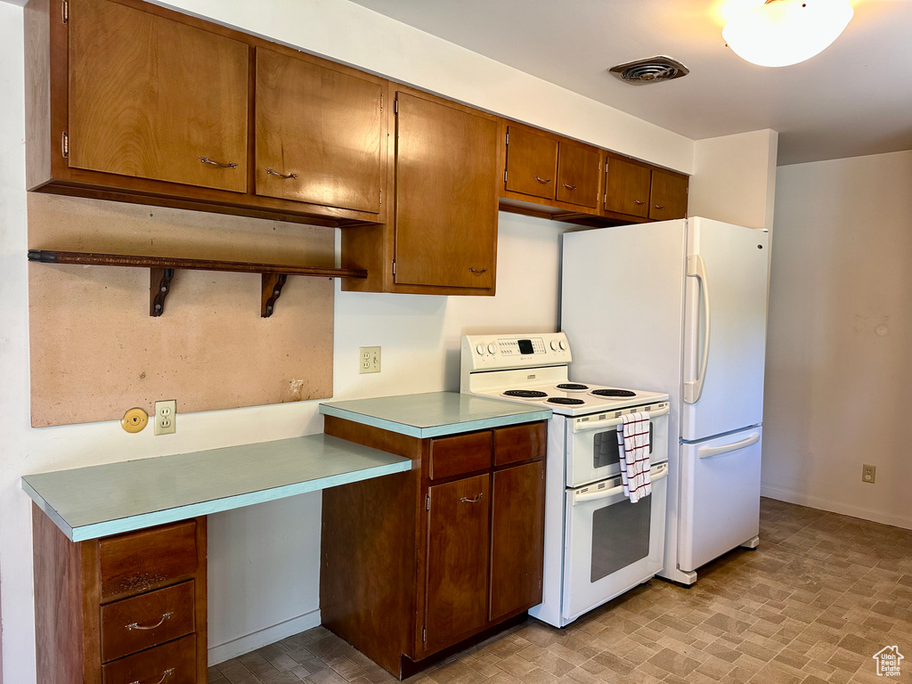 Kitchen featuring white appliances and light countertops