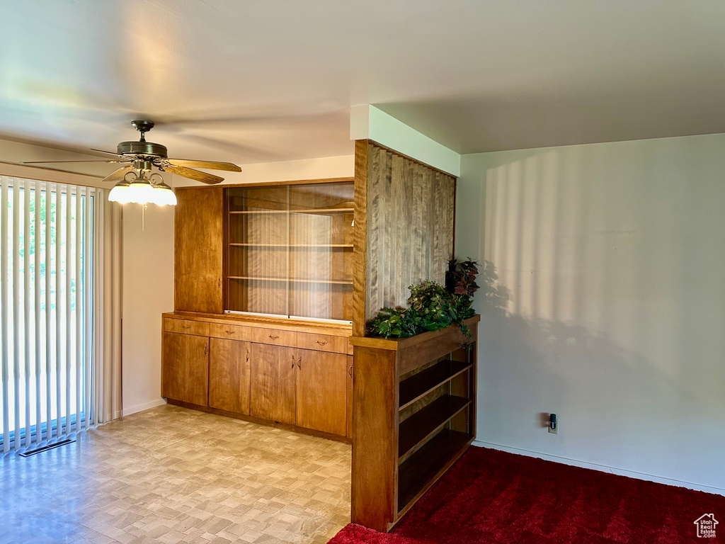 Unfurnished room with ceiling fan and baseboards