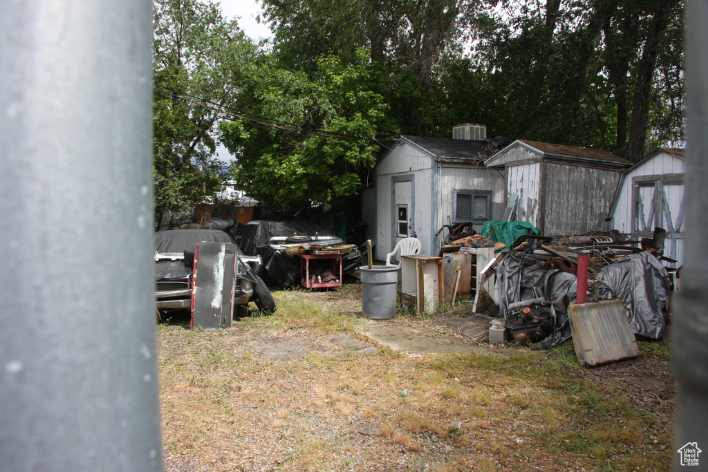 View of yard featuring a shed and an outbuilding