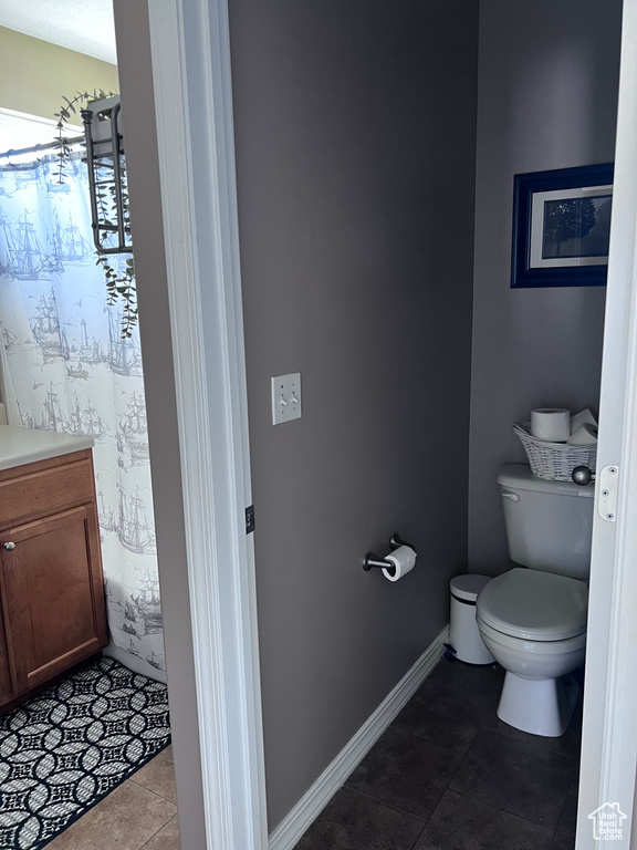 Bathroom with tile patterned floors and vanity