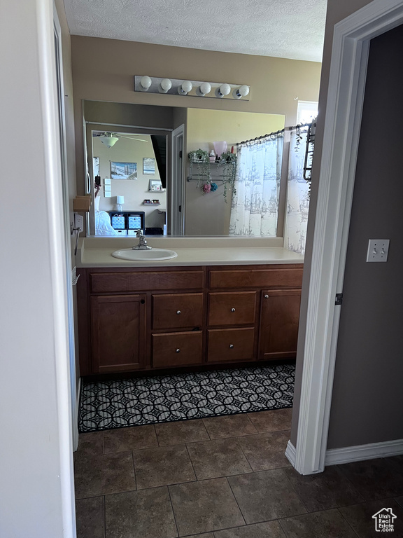Bathroom featuring vanity and a textured ceiling