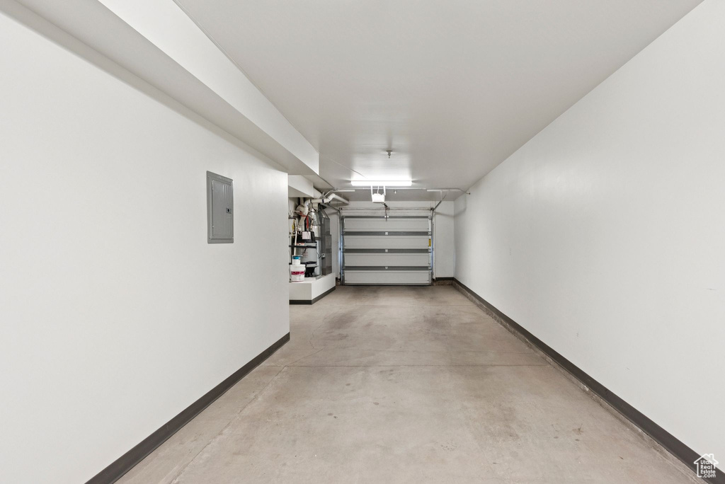 Garage with electric panel and baseboards