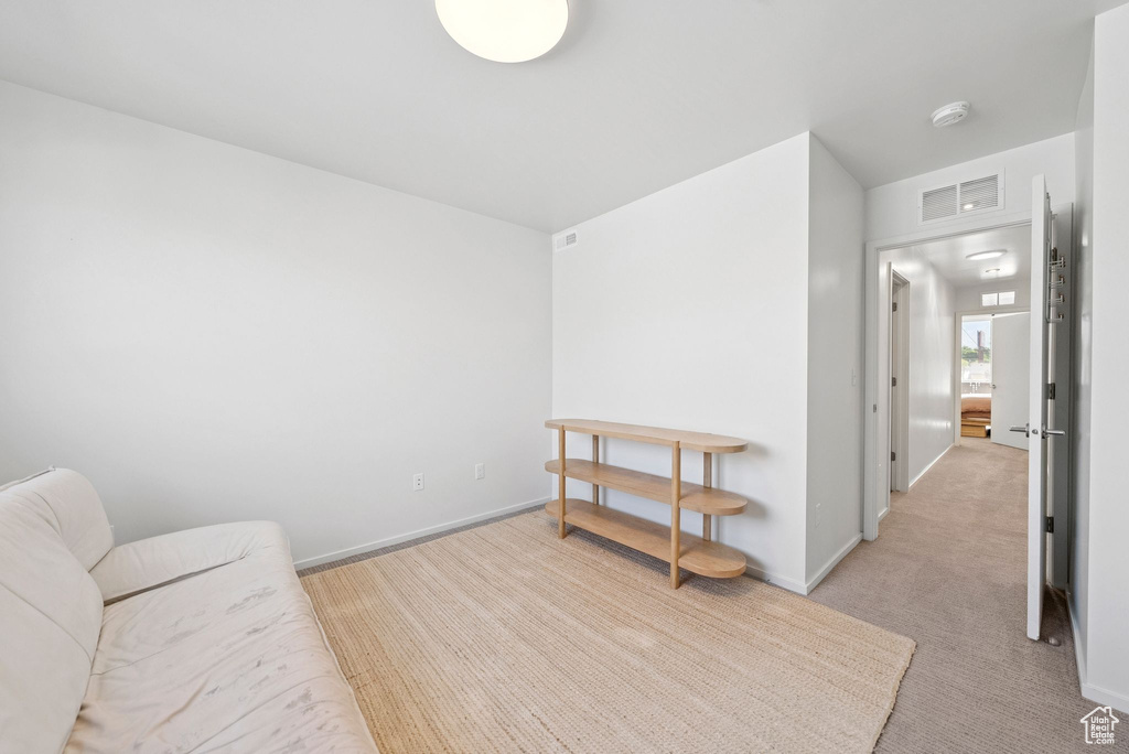 Sitting room featuring light colored carpet and baseboards