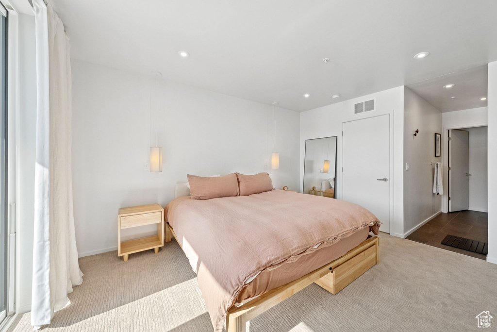 Carpeted bedroom with recessed lighting