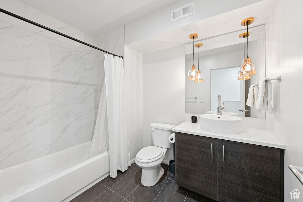 Full bath featuring vanity and shower / tub combo with curtain