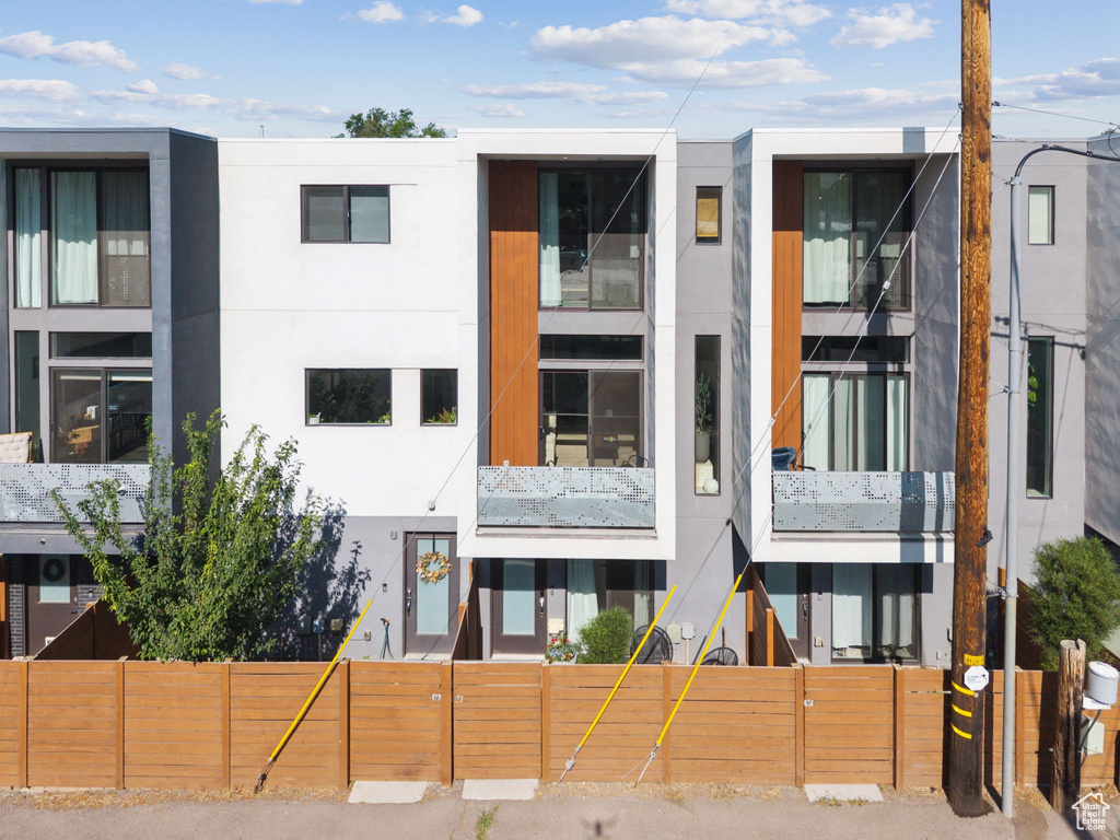 View of property featuring a fenced front yard