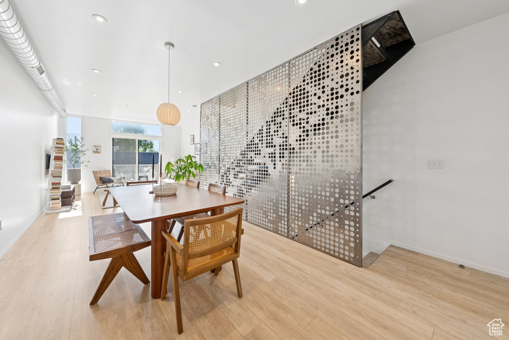 Dining space with wood finished floors and recessed lighting