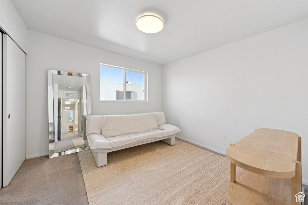 Living area with carpet flooring and baseboards