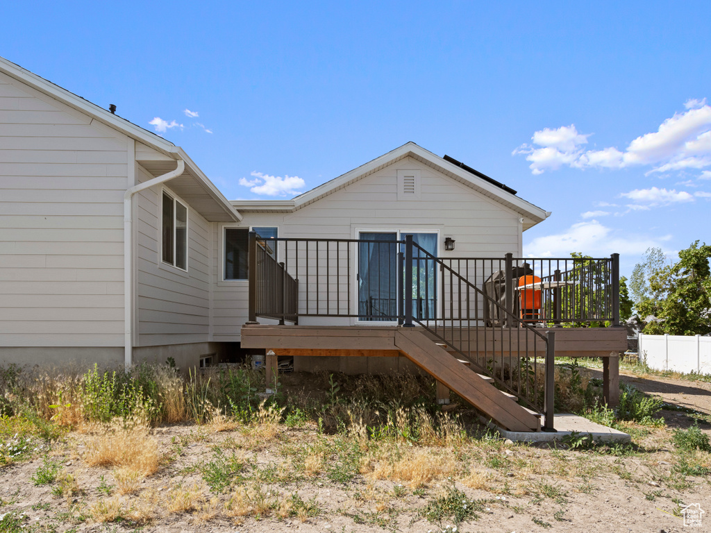 Back of property with a deck