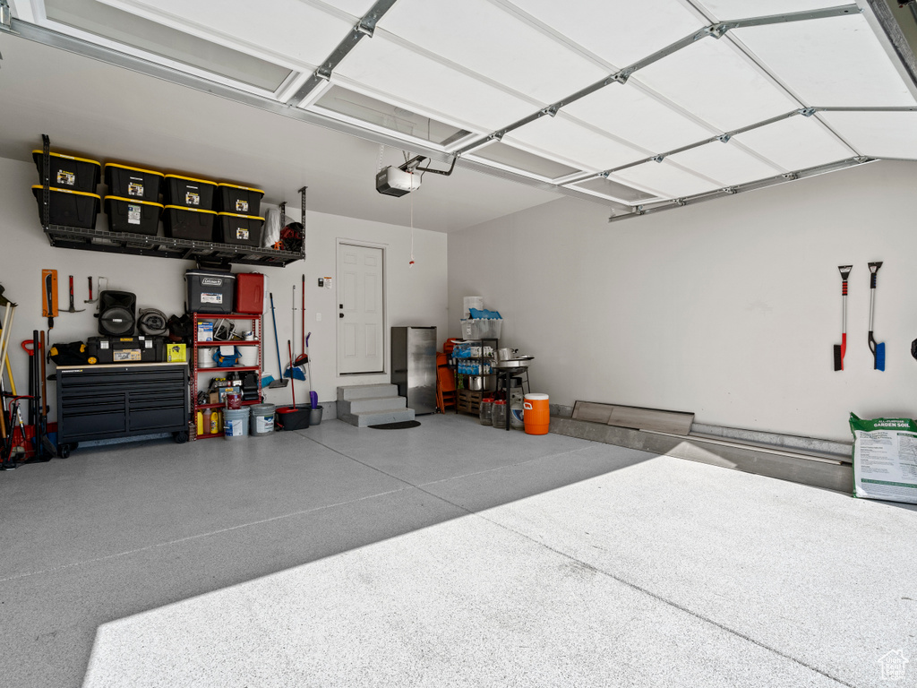 Garage with a workshop area and a garage door opener