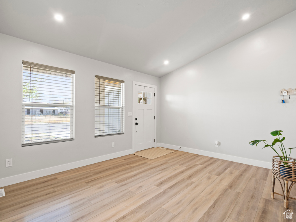 Entrance foyer with light wood finished floors and recessed lighting