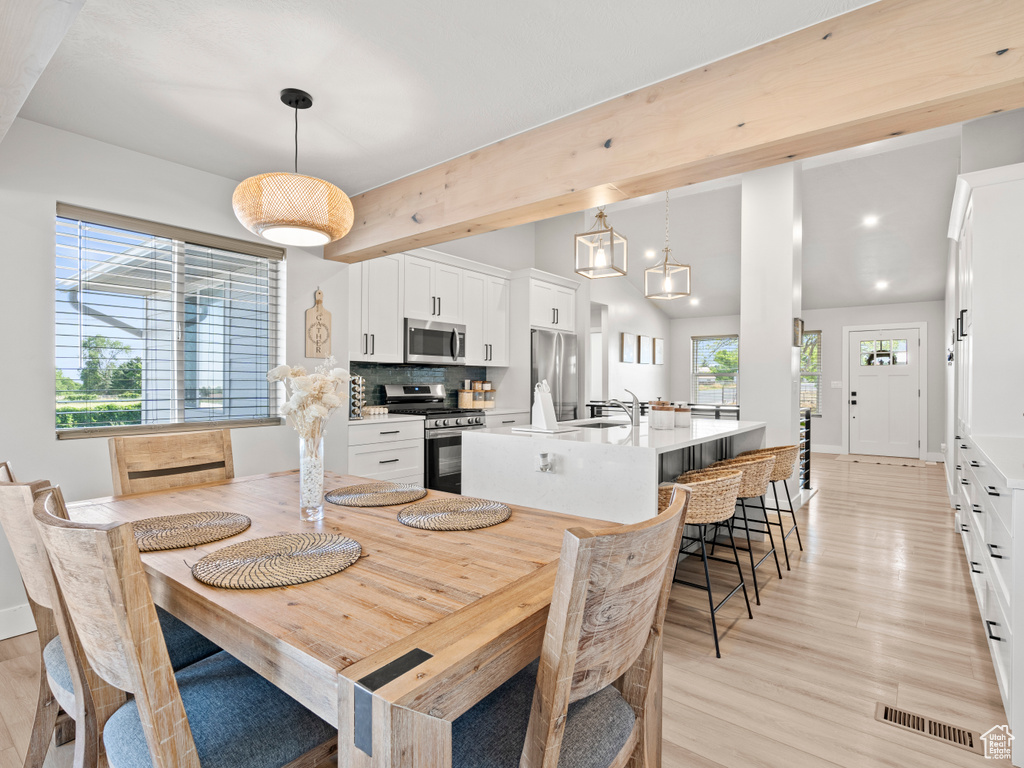 Dining room featuring light wood-style flooring and baseboards