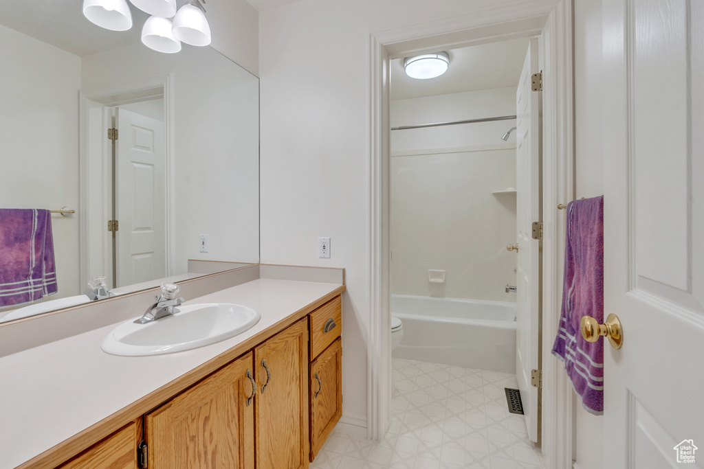 Full bath featuring vanity, tile patterned floors, and shower / tub combination