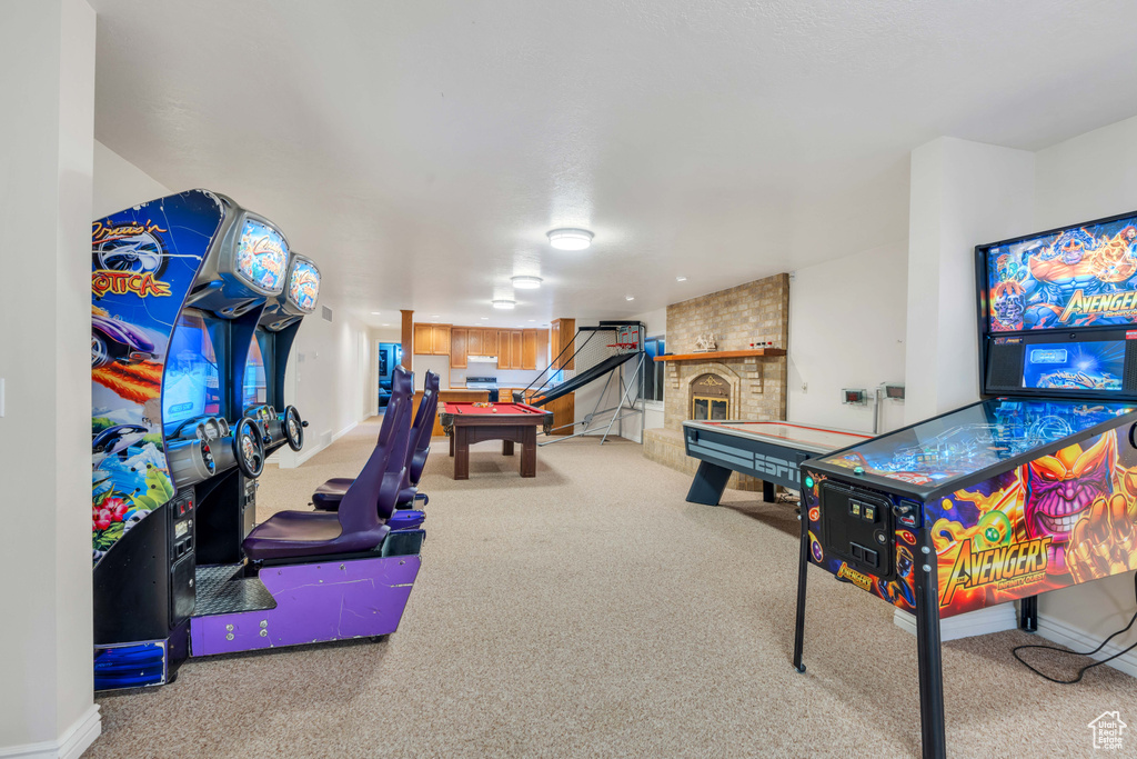 Playroom featuring carpet flooring, billiards, and a fireplace