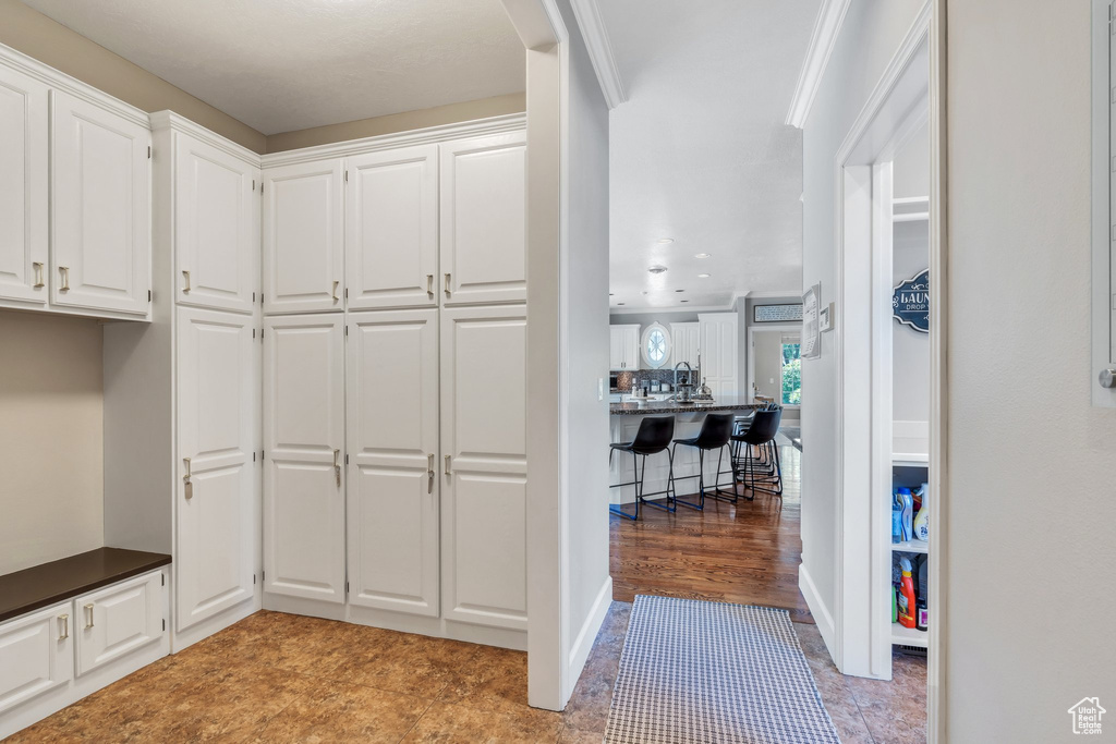 Mudroom with arched walkways and recessed lighting
