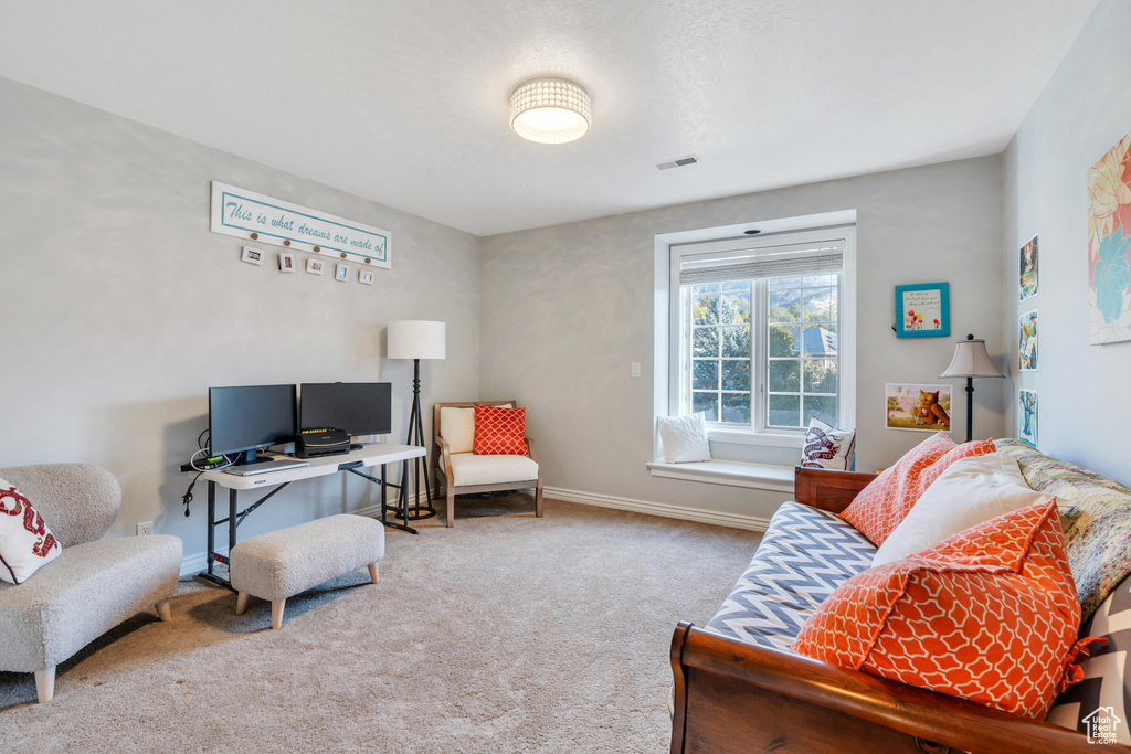 Living area with carpet flooring and baseboards