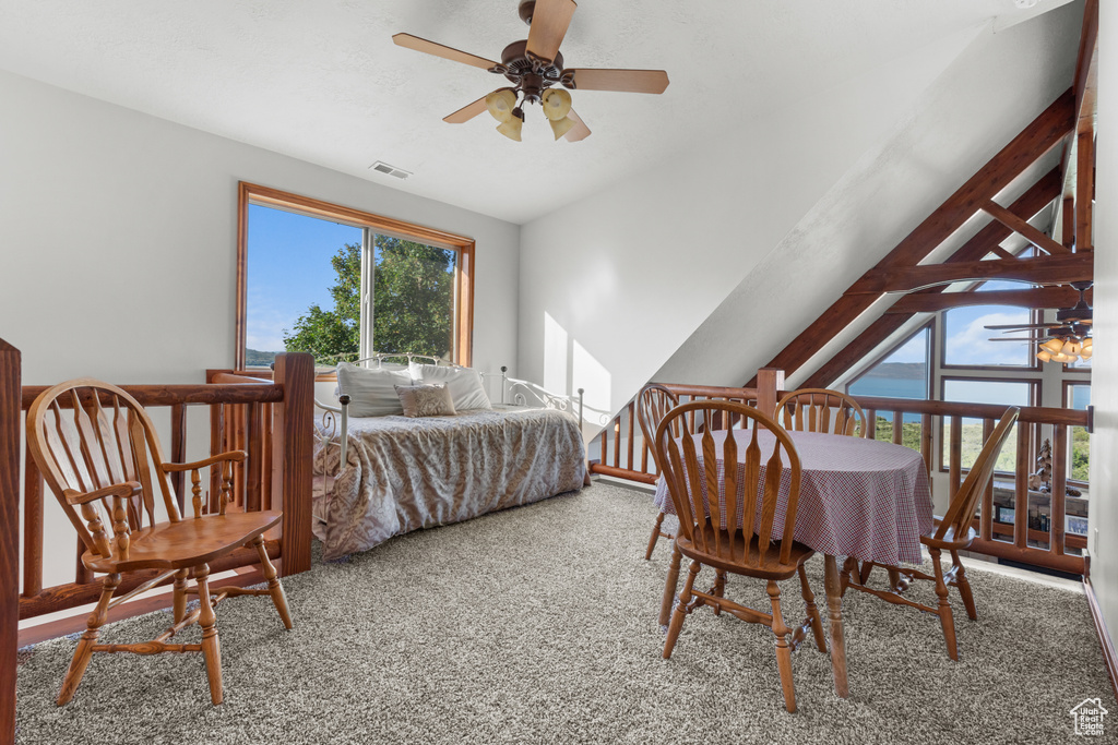 Bedroom featuring carpet, lofted ceiling, and a ceiling fan