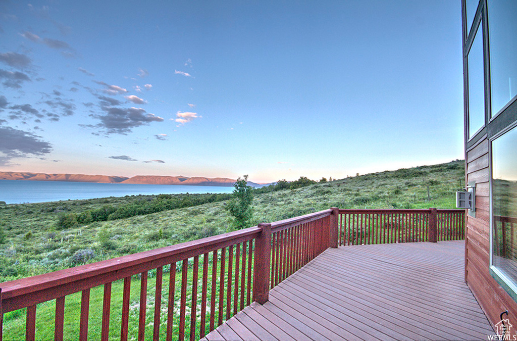 Wooden deck featuring a water view