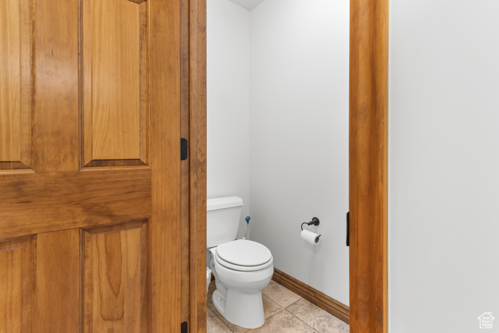 Bathroom featuring toilet and tile patterned flooring