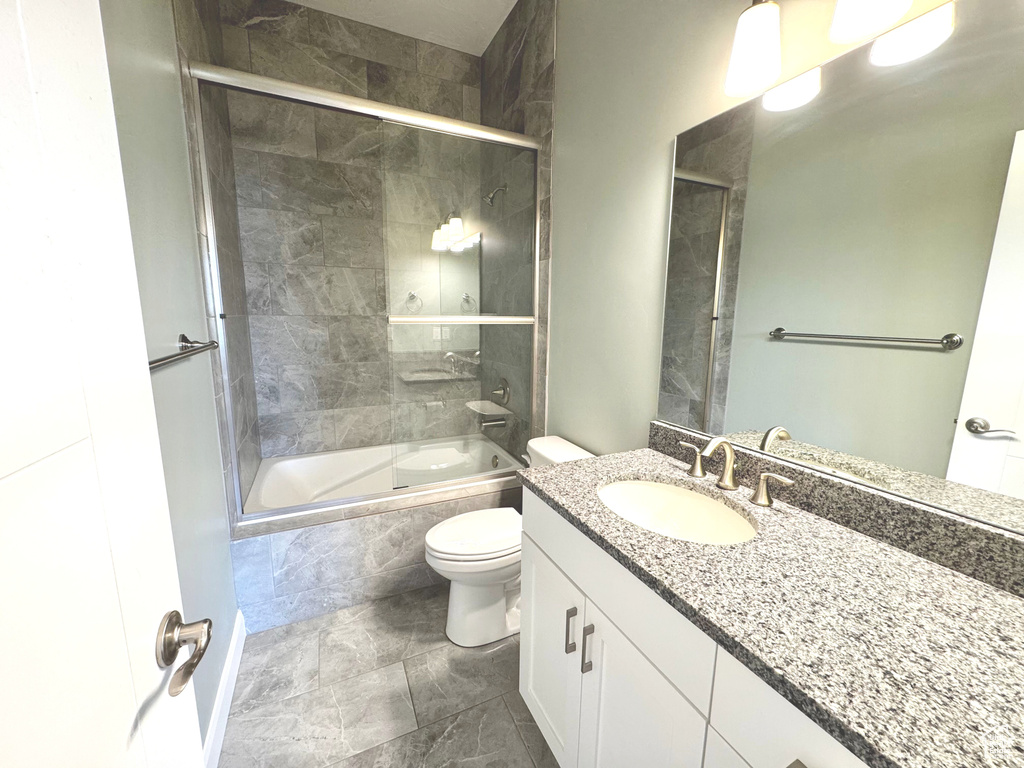 Bathroom with tiled shower / bath combo and vanity