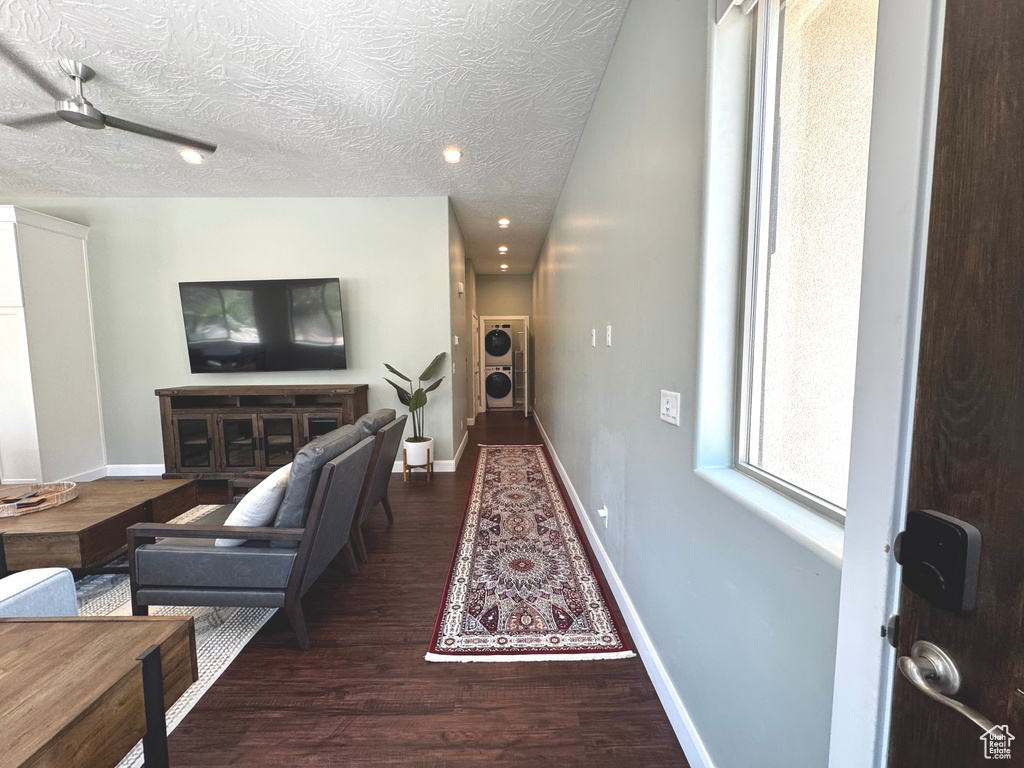 Living room featuring wood finished floors, a textured ceiling, and recessed lighting
