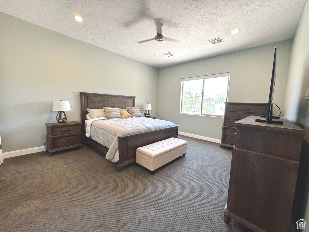 Bedroom featuring dark colored carpet, ceiling fan, a textured ceiling, and recessed lighting