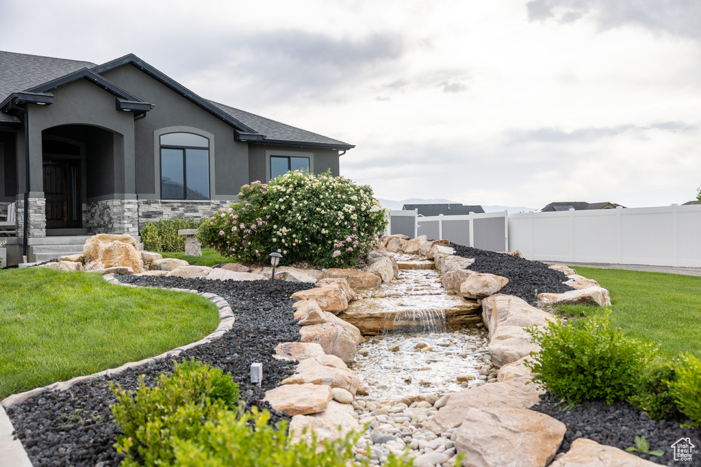 View of yard featuring a small pond