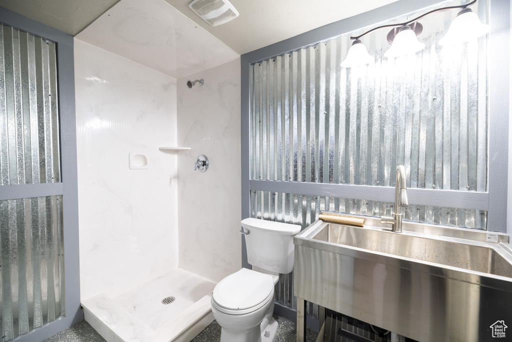 Full bathroom with toilet and a shower stall