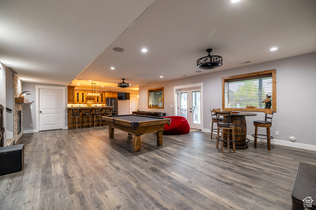 Game room featuring a bar, billiards table, dark wood-style flooring, recessed lighting, and french doors