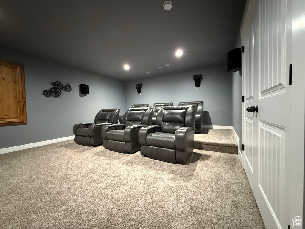 Carpeted home theater room featuring recessed lighting and baseboards