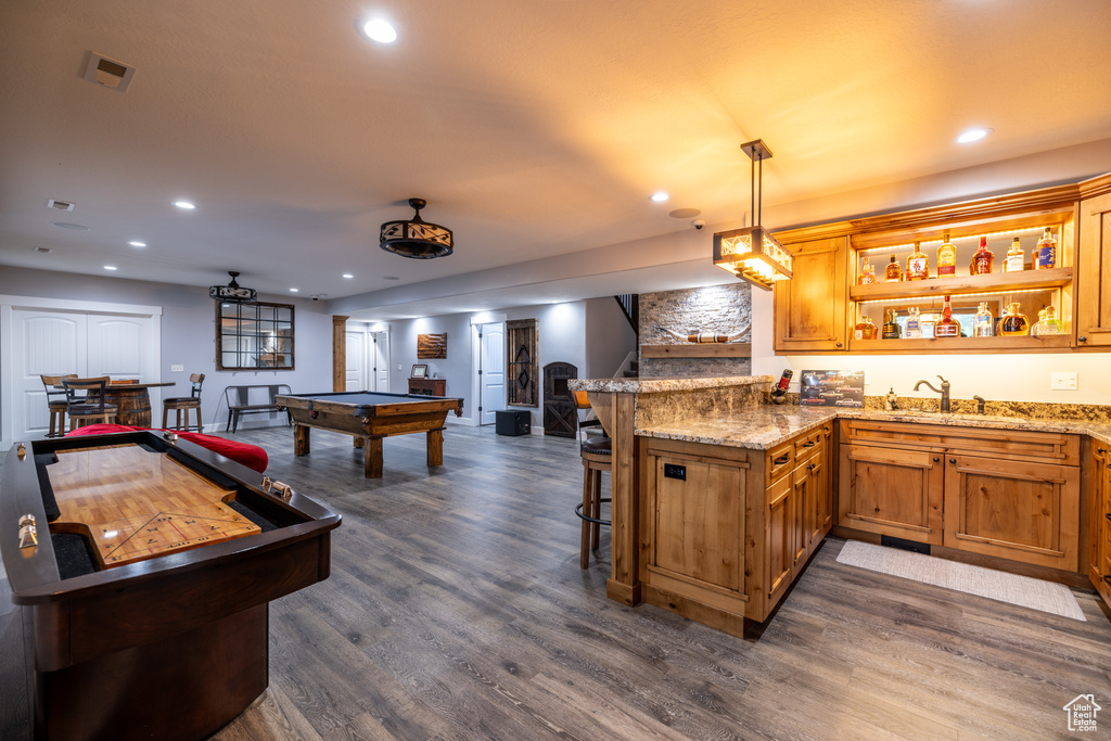 Recreation room with wet bar, pool table, dark wood-type flooring, and recessed lighting