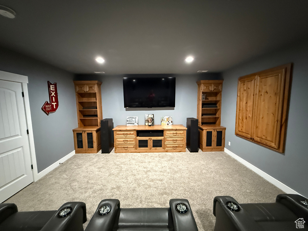 Home theater room with recessed lighting and carpet floors
